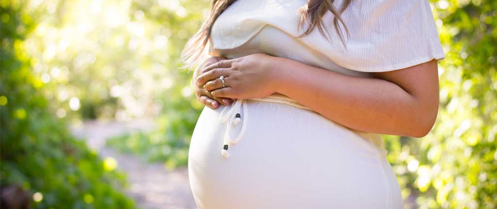 Pregnant woman holding belly